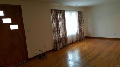 Livingroom with gleaming hardwood floors.