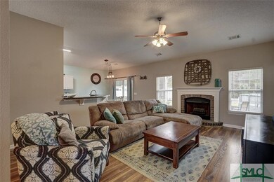 Great Room with wood floors, fireplace and open to