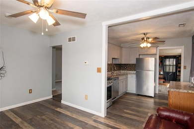 Living room looking into kitchen and hallway