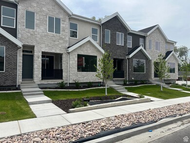 View of front of house featuring stone siding and a front yard
