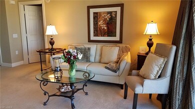 Carpeted living area featuring baseboards