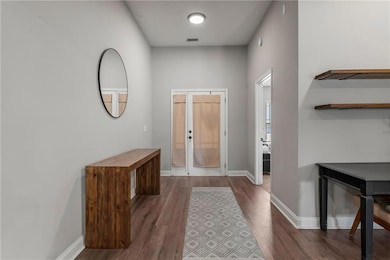 Entryway featuring wood finished floors and french doors