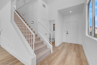 Foyer entrance featuring baseboards, stairs, light