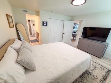 Bedroom featuring light wood finished floors and a closet