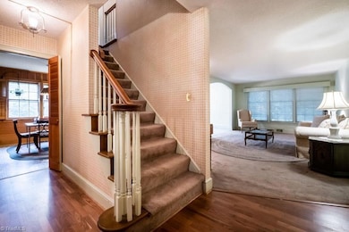 Welcoming foyer opens to kitchen to the left, staircase and formal living room to the right.
