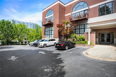View of building exterior with uncovered parking