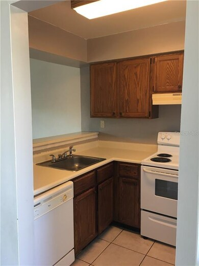 Kitchen has counter bar seating and pass through t