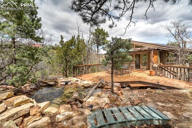 View of yard with a deck, pond, waterfall