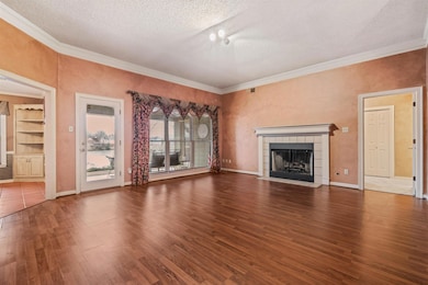 Unfurnished living room featuring dark wood-type f