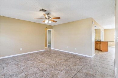 Tiled empty room with ceiling fan