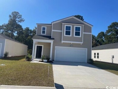 View of front facade featuring concrete driveway, a garage, and a front yard