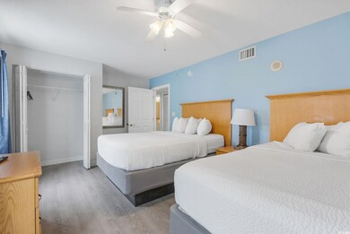 Bedroom with ceiling fan, wood-type flooring, and 