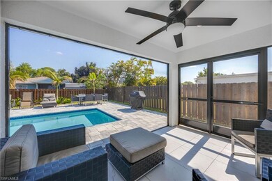 View of swimming pool featuring ceiling fan, a pat