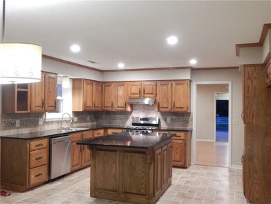 Tastefully updated kitchen with granite, tile back