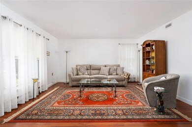 Living room featuring wood finished floors, basebo