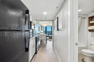Full bathroom with washtub / shower combination, hardwood / wood-style flooring, vanity, and toilet