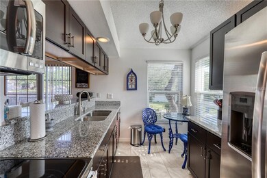 Kitchen with eat-in area & breakfast bar on left.