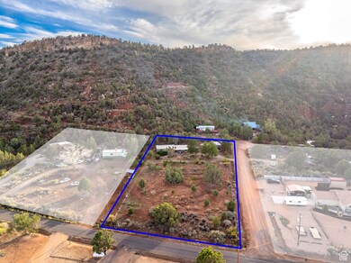 Aerial view of property's location featuring a mountain backdrop and property parcel outlined