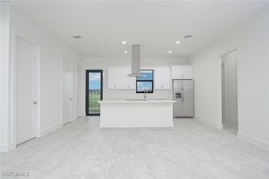 Kitchen featuring white cabinets, a kitchen island