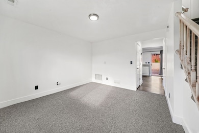 Carpeted empty room with baseboards