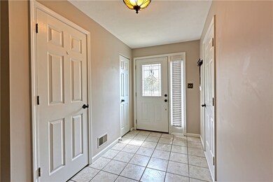 The entryway has a half bath, coat closet, and doo