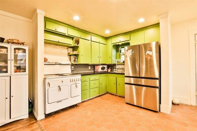 Kitchen featuring green cabinets, stainless steel 