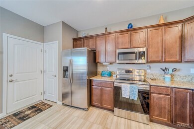 Kitchen with light stone countertops and stainless