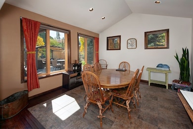 Dining space featuring vaulted ceiling, recessed l