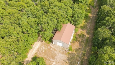 View of subject property featuring a heavily wooded area