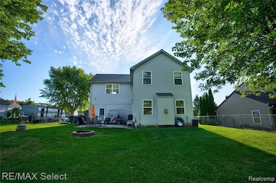 Back of property featuring a patio, a fenced backyard, and an outdoor fire pit
