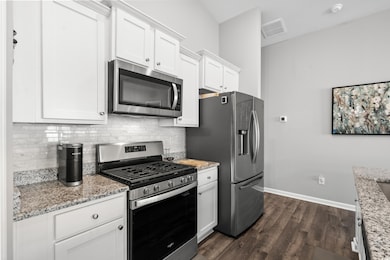 Kitchen with stainless steel appliances, light sto