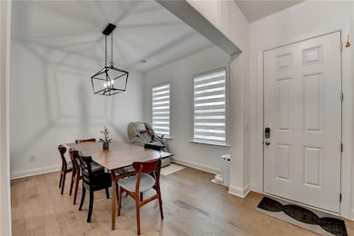 Dining space featuring a notable chandelier, light