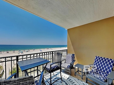 Balcony featuring a view of the beach and a water view