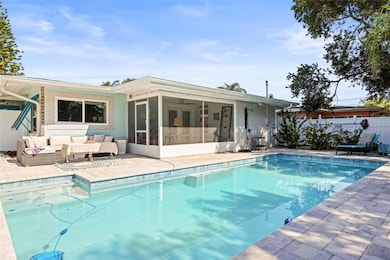 Stunning back yard space with screened lanai, outdoor shower and sparkling pool
