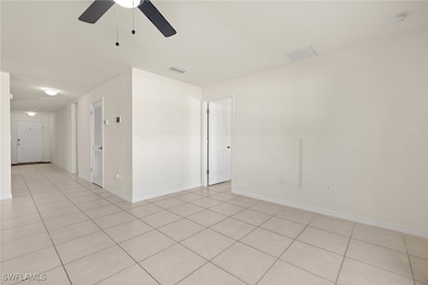 Empty room featuring ceiling fan, a smoke detector