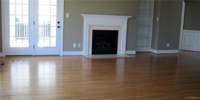 Living Room Features Hardwood Floors & Gas Firepla
