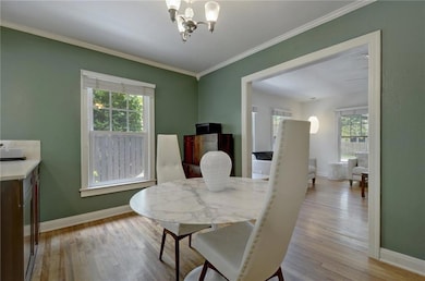 Dining room with baseboards, wood finished floors