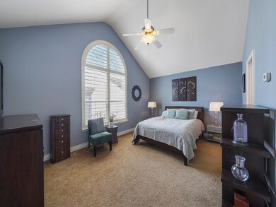 Owner's suite with high ceilings and custom wood shutters