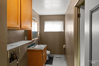 Half bathroom with vanity and toilet