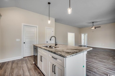 Kitchen with stainless steel dishwasher, sink, a c