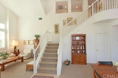 Dramatic staircase gracefully flows to upper level
