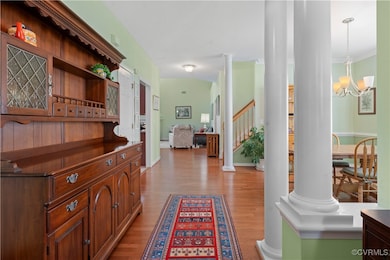 Hallway featuring wood finished floors, stairs, or