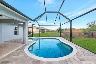 View of swimming pool featuring glass enclosure, a