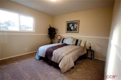 Chair railing and new carpet in large guest bedroo