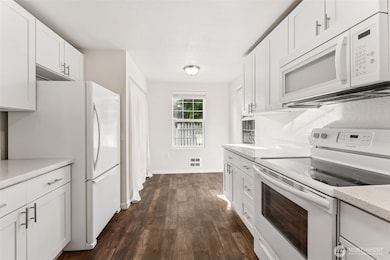 Kitchen w/ updated cabinetry, flooring & quartz counters.