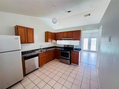 Kitchen looking into the bonus room area.