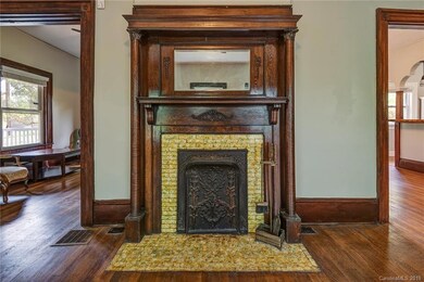 Detail view of fireplace and original mantle, with view to family room to left, and dining room to right.