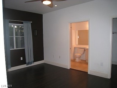 Unfurnished bedroom featuring dark wood finished f