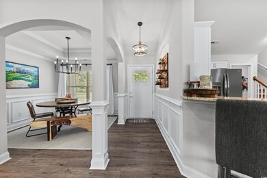 Entryway featuring decorative columns, a raised ce