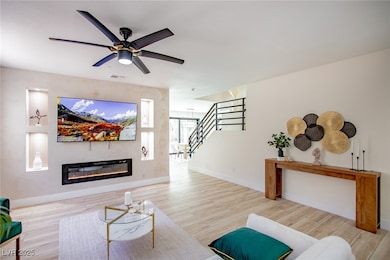 Living room with stairway, visible vents, baseboar